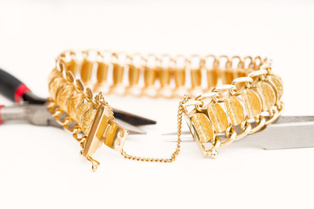 Detail of a gold bracelet on white backgroundの写真素材