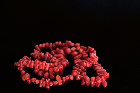 Detail of a red coral necklace on black backgroundの写真素材