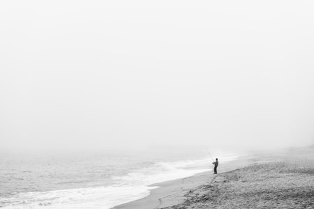 Fisherman on a secluded beachの写真素材