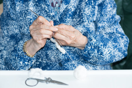 Older person doing a knitted sweaterの写真素材