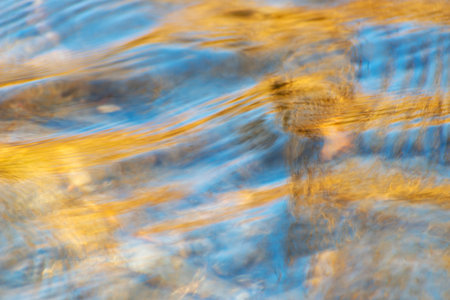 Different shapes and textures of colors made in the water of a riverの写真素材