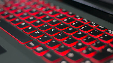 Gaming laptop with red backlit keyboard online.の写真素材