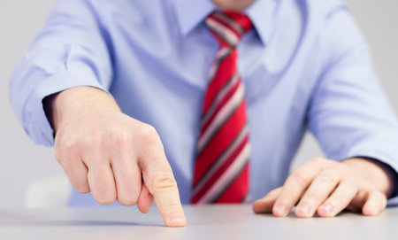 Universal sign of doing something quickly and finishing it yesterday - finger pointing on the table.の写真素材