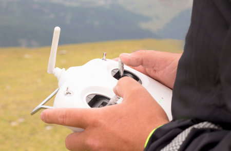 White drone remote control in man hands.