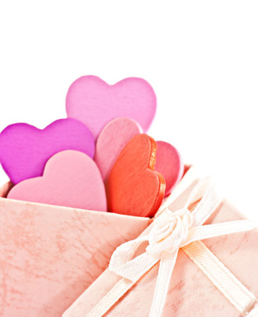 Wooden heart-shaped pink color Gift Box on the white background. Macro photo.の写真素材