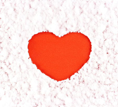 A red heart on the artificial snow backgroundの写真素材