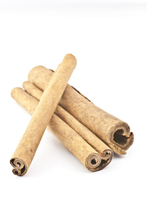 Three cinnamon sticks on a white background. Macro photography.の写真素材