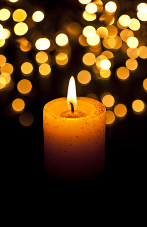 On a black background standing in a burning candleの写真素材