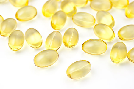 Nutritional supplement pills in warm colors and shallow depth of field. The yellow ones are vitamin E and cod liver oil.の写真素材