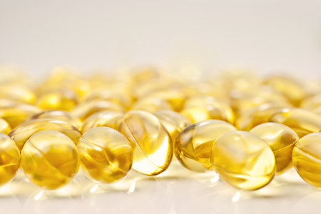 Nutritional supplement pills in warm colors and shallow depth of field. The yellow ones are vitamin E and cod liver oil.の写真素材