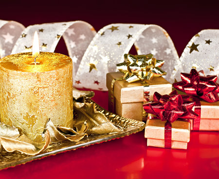 Christmas Decor, on a red background, candles, gift boxes and Bantu with the stars.の写真素材