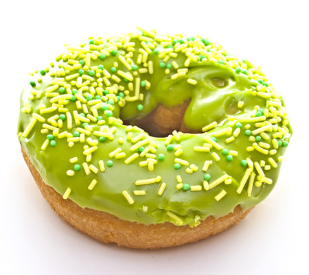 Donut on a white background with green glaze.の写真素材