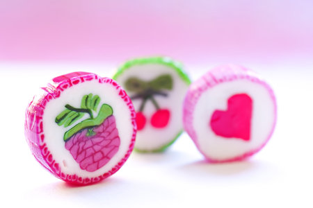 Three fruit candy on pink background.の写真素材