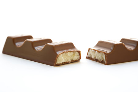 Bar of chocolate photographed on a white background.の写真素材