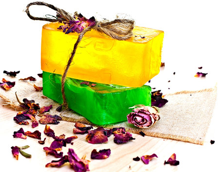 Yellow and green soap bar tied with string, dry rose.の写真素材