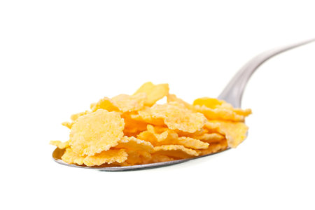 Spoon the corn flakes on a white background.の写真素材