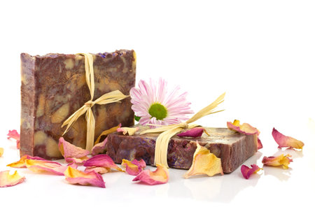 Natural handmade silk soap and pink flower on a white background.の写真素材