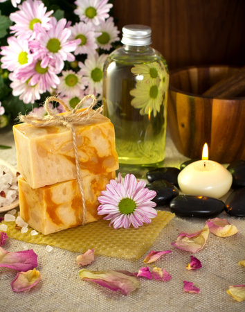 Natural soap from honey. Olive oil, massage stones with a candle, mortar with a pestle. Health spa for spa treatment.の写真素材