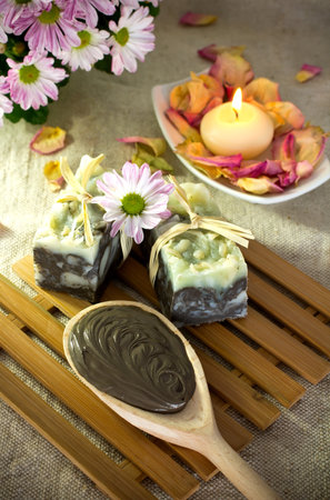 Spa treatment. Clay, burning candle, natural soaps, rose petals.の写真素材