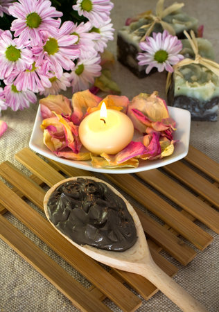 Spa treatment. Clay, burning candle, natural soaps, rose petals.の写真素材