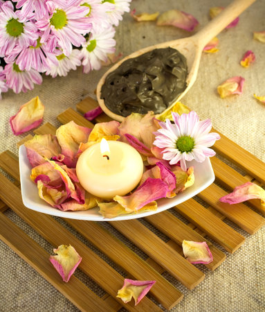 Spa treatment. Clay, burning candle, rose petals.の写真素材