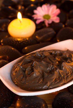 Spa treatment. Clay, burning candle, spa stones, pink flowers.の写真素材