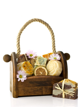 Composition of the basket full of handmade soap, isolated on white background.の写真素材