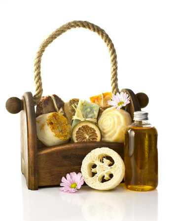 Composition of the basket full of handmade soap, isolated on white background.の写真素材