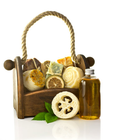 Composition of the basket full of handmade soap, isolated on white background.の写真素材