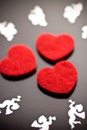 Three red hearts on a gray background.