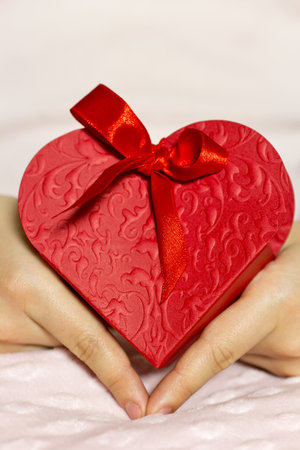 The hands of children in heart gift box.の写真素材