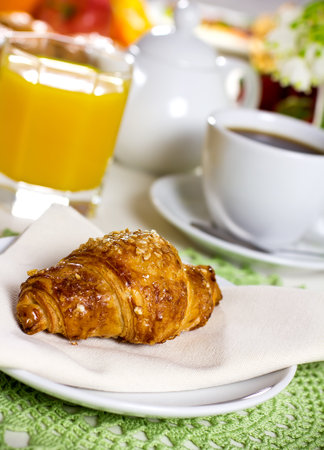 Tasty breakfast  Croissants with coffee, fresh juice and fruit の写真素材