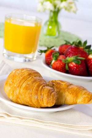 Tasty breakfast  Croissants with juice, and fresh  strawberries の写真素材