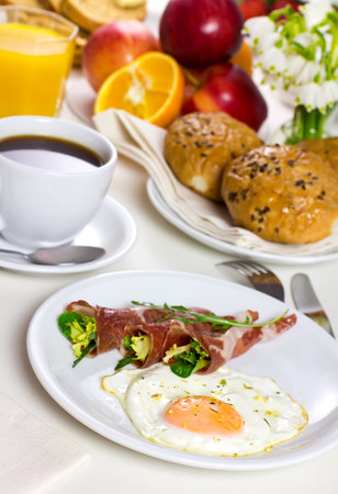 Tasty breakfast, fried eggs with bacon juice and coffee  Fresh fruit の写真素材