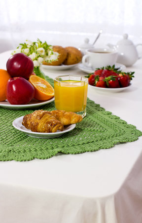 Tasty breakfast  Croissants with coffee, fresh juice and fruit の写真素材
