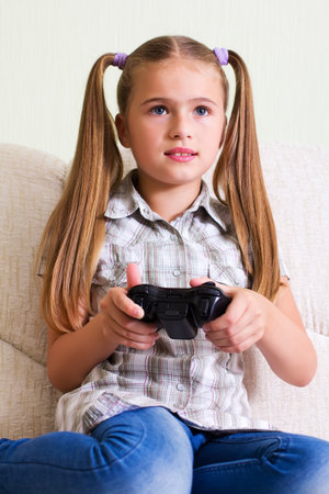 A teenaged girl playing video, computer  game.
