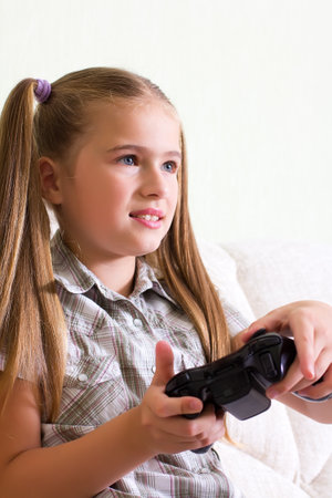 A teenaged girl playing video, computer  game 