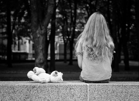 Young girl sitting in a park  Black and white photography の写真素材