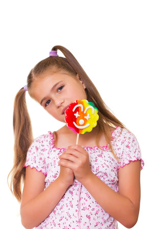 Girl and a lollipop, isolated on the white background の写真素材