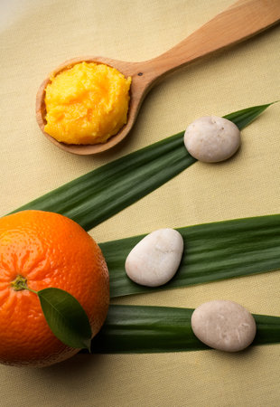 Mango body butter, spa stones, green leaf and orange.の写真素材