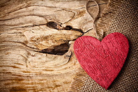 On wooden background red wooden heart.の写真素材