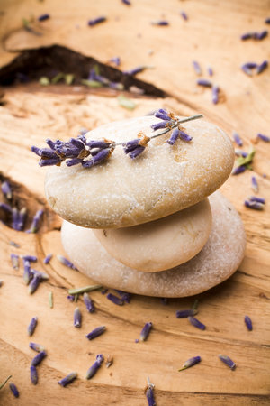 Spa stones with dried lavender flowers.の写真素材