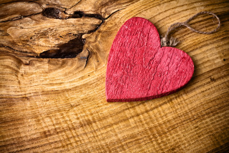 On wooden background red wooden heart の写真素材