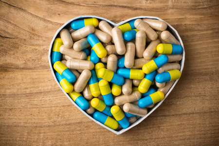 Herbal drug capsules, a heart-shaped box  Wooden surface  Alternative medicine concept  の写真素材