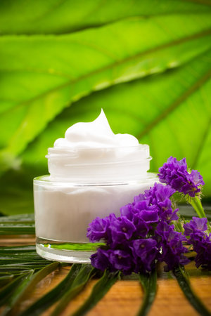 Face cream tubs on green background.の写真素材