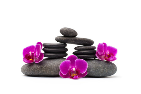 Spa stones and pink orchid isolated background.の写真素材