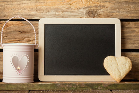 Heart of the cookies and blackboard,  wooden background.の写真素材