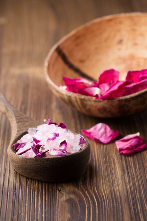 Homeopathic medicine, rose dry flowers and wooden surface.の写真素材