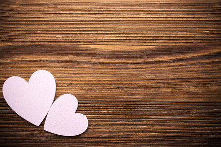 Wood hearts on a wooden background.の写真素材