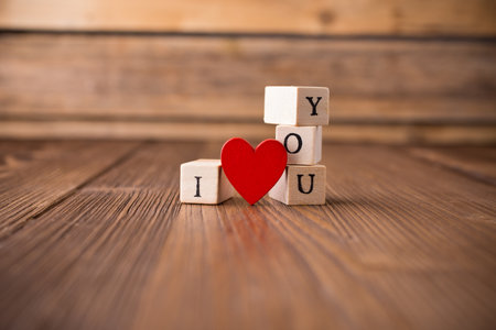 Love message written in wooden blocks. Red heart.